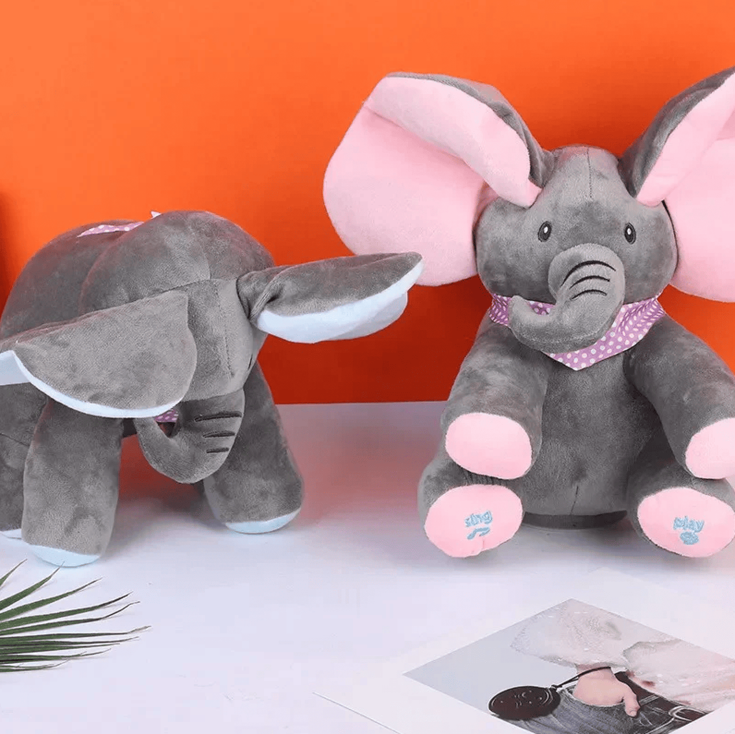 Baby laughing while playing with interactive elephant toy