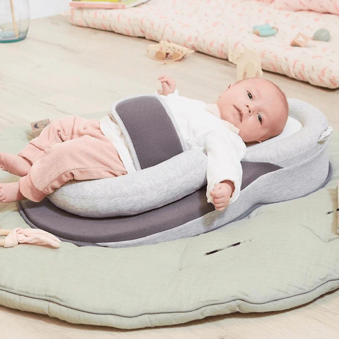 Infant sleeping on CozyNest ergonomic anti-reflux pillow
